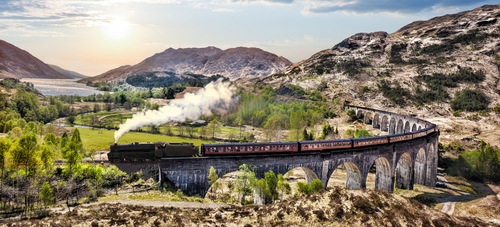 The Jacobite steam train crossing the Glenfinnan Viaduct in the Scottish Highlands